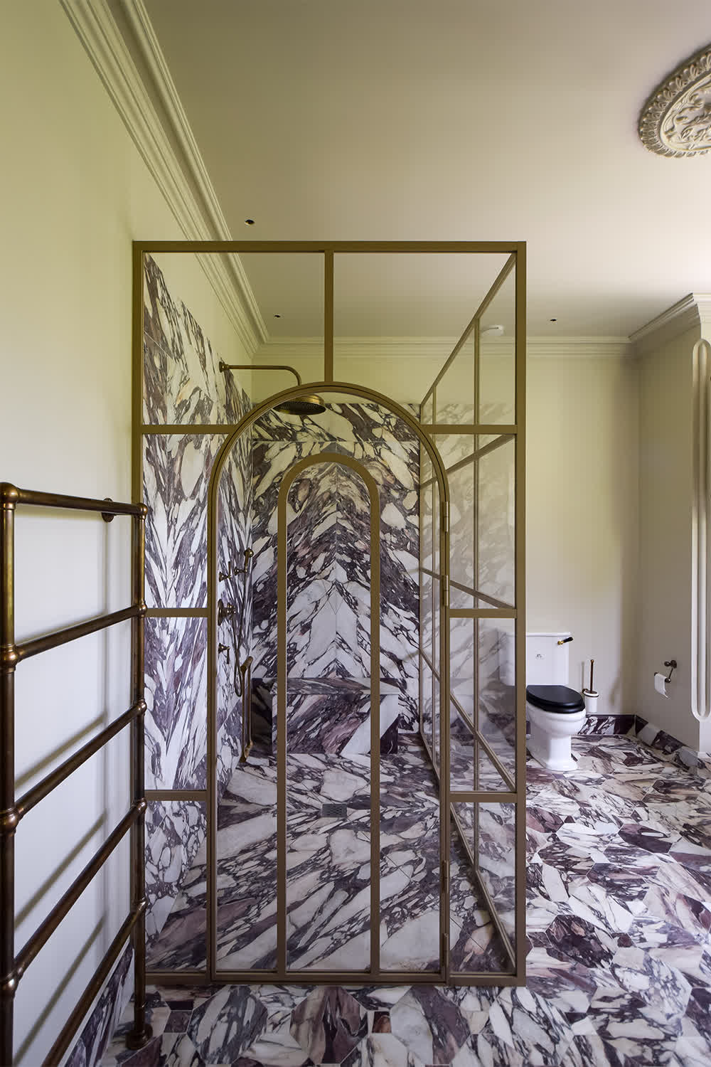 framed shower enclosure with an arched door