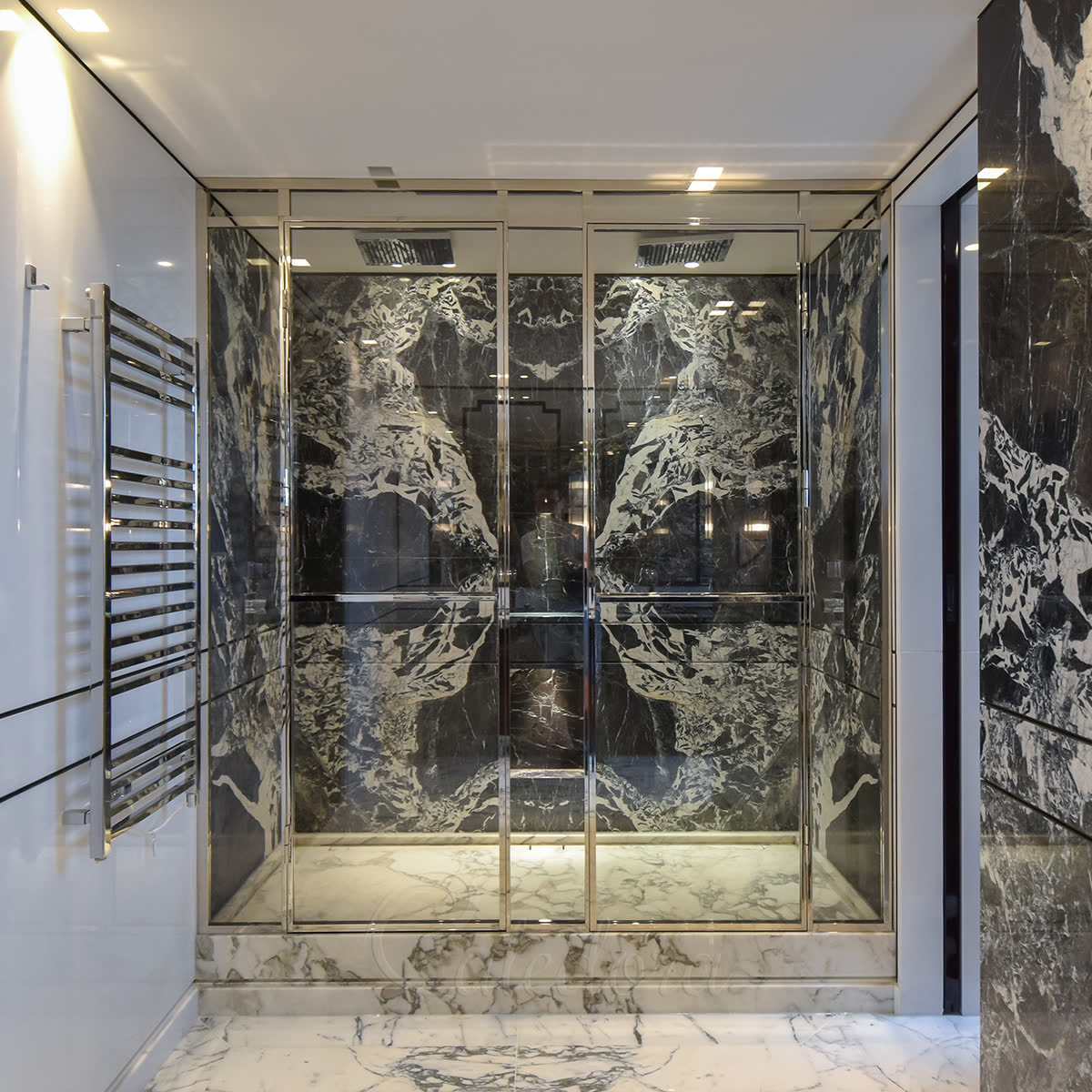 Premium polished-nickel mirror-finish glass shower enclosure with double hinged doors and full-height frameless glass — high-end trade specification