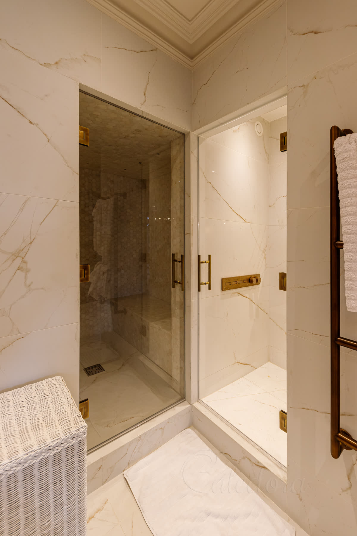 Steam room and shower doors with antique brass hardware in Leicester bathroom