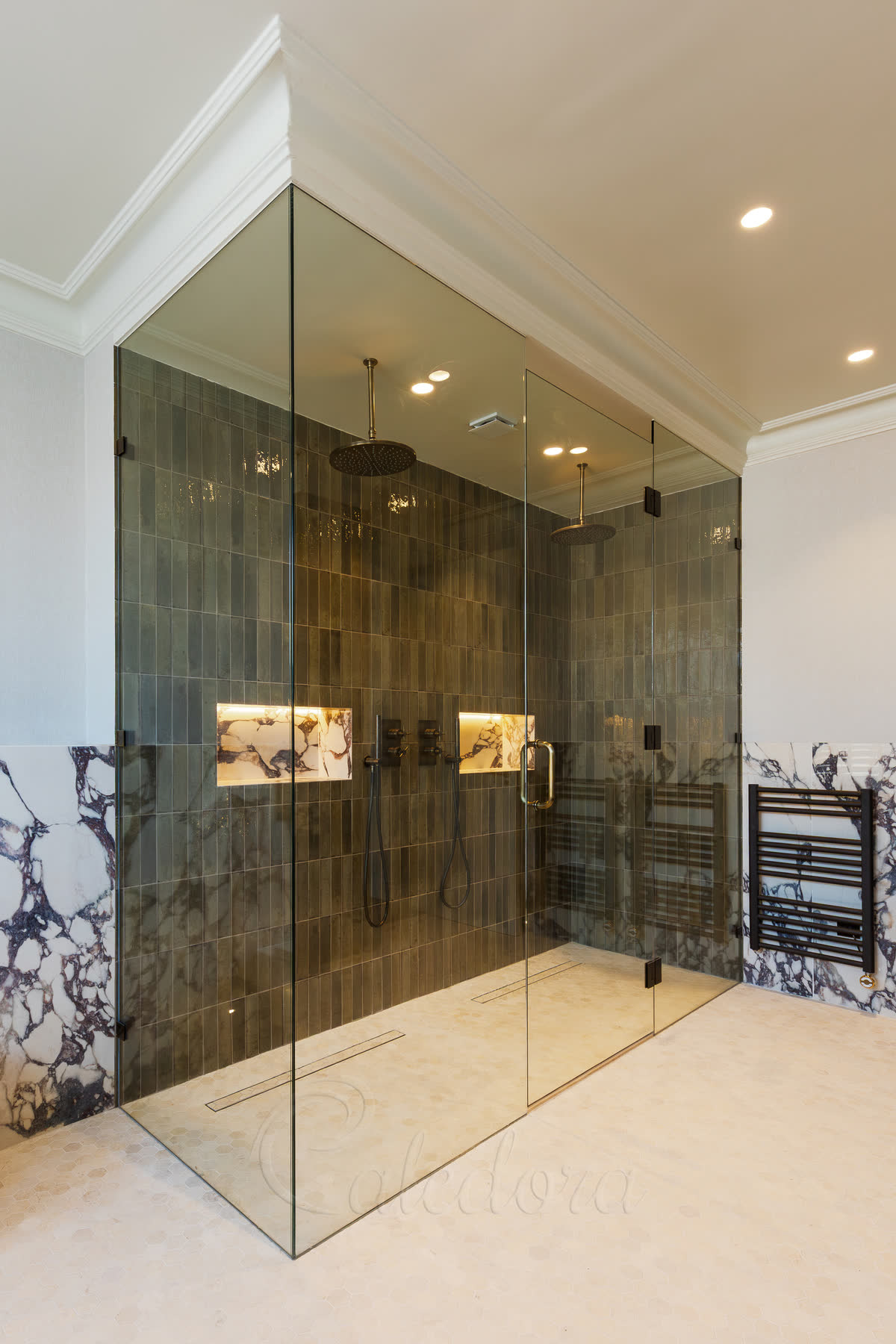 Large shower enclosure with double shower heads and brass hardware